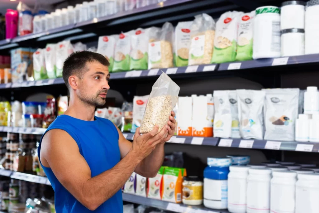 Man holding pre-workout supplements.